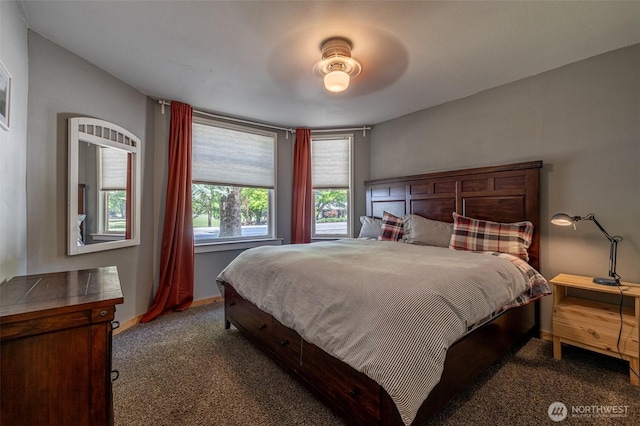 carpeted bedroom featuring baseboards