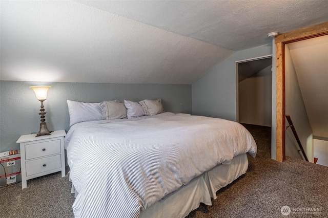 bedroom featuring carpet, vaulted ceiling, and a textured ceiling