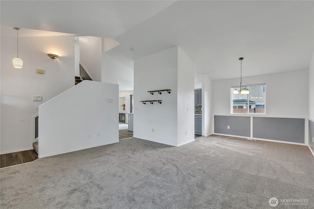1108 200th Street Ct E, Spanaway, WA 98387 - unfurnished living room with stairway, a chandelier, carpet floors, vaulted ceiling, and baseboards