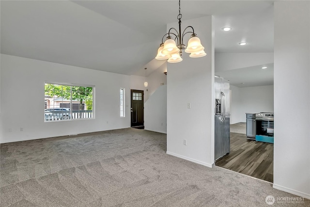 1108 200th Street Ct E, Spanaway, WA 98387 - unfurnished living room with dark colored carpet, vaulted ceiling, a chandelier, baseboards, and recessed lighting