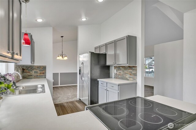 1108 200th Street Ct E, Spanaway, WA 98387 - kitchen with a sink, dark wood finished floors, tasteful backsplash, light countertops, and high vaulted ceiling