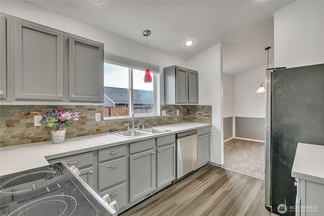 1108 200th Street Ct E, Spanaway, WA 98387 - kitchen with gray cabinets, appliances with stainless steel finishes, a sink, wood finished floors, and pendant lighting