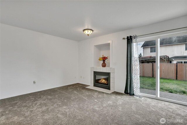 1108 200th Street Ct E, Spanaway, WA 98387 - unfurnished living room featuring carpet, a tiled fireplace, and baseboards