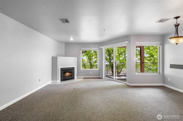2900 W Marina Dr Unit 303, Moses Lake, WA 98837 - unfurnished living room with healthy amount of natural light, carpet floors, and baseboards