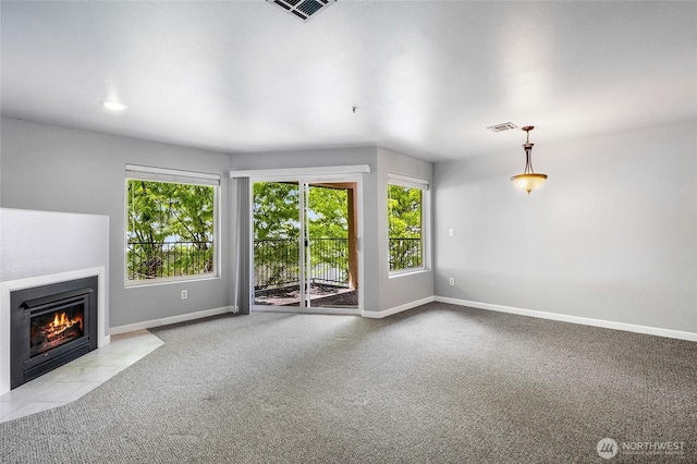 2900 W Marina Dr Unit 303, Moses Lake, WA 98837 - unfurnished living room with baseboards, a fireplace with flush hearth, and carpet