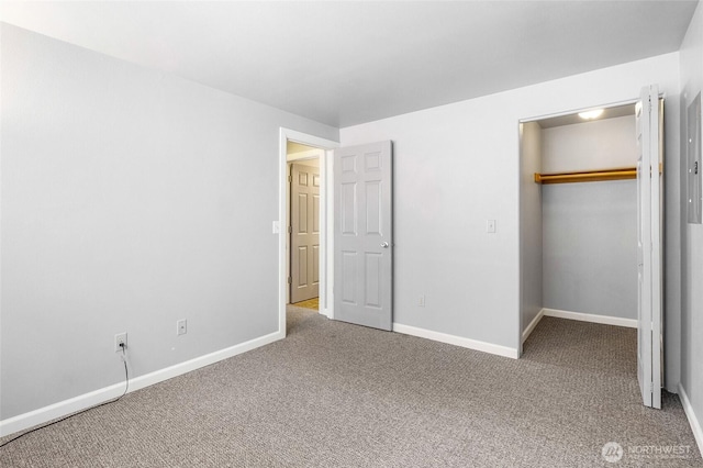 2900 W Marina Dr Unit 303, Moses Lake, WA 98837 - unfurnished bedroom featuring a walk in closet, carpet floors, and baseboards