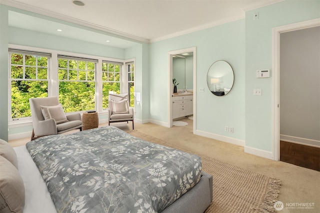 carpeted bedroom featuring baseboards and connected bathroom