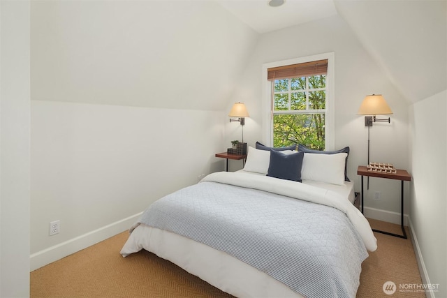carpeted bedroom with lofted ceiling and baseboards