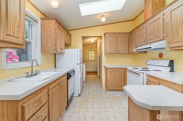 kitchen featuring white appliances, under cabinet range hood, vaulted ceiling, a sink, and light countertops