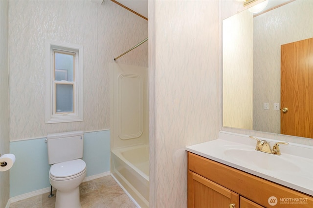 full bathroom featuring toilet, vanity, bathtub / shower combination, tile patterned flooring, and baseboards