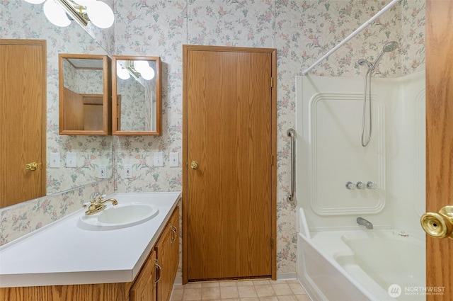 bathroom featuring bathing tub / shower combination, wallpapered walls, tile patterned flooring, and vanity