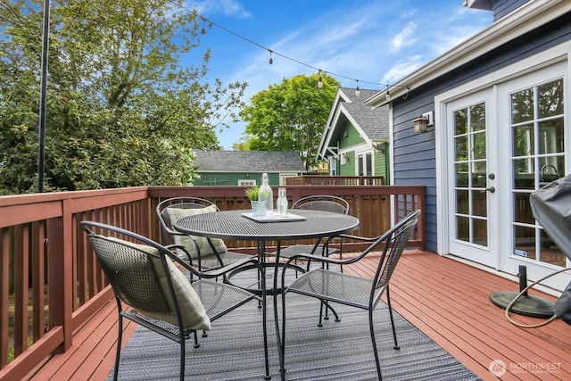 deck featuring outdoor dining space and french doors