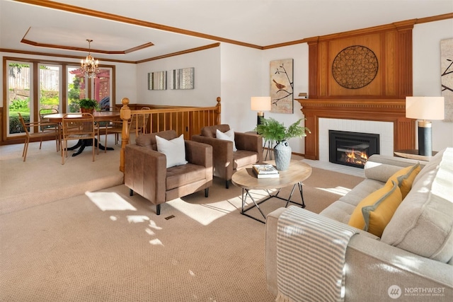 4816 118th Ave NE, Kirkland, WA 98033 - living room featuring a chandelier, carpet floors, crown molding, a raised ceiling, and a fireplace