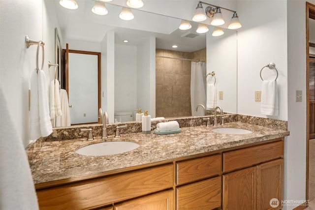 4816 118th Ave NE, Kirkland, WA 98033 - bathroom featuring toilet, double vanity, and tiled shower