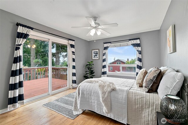 bedroom with access to outside, wood finished floors, and ceiling fan