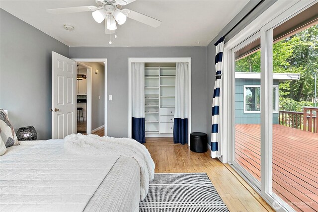 bedroom featuring wood finished floors, a ceiling fan, and a closet
