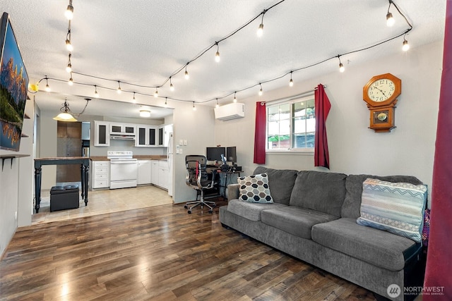 714 S 43rd St, Tacoma, WA 98418 - living area with light wood-style flooring, a textured ceiling, a desk, an AC wall unit, and rail lighting