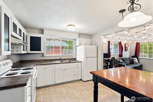 714 S 43rd St, Tacoma, WA 98418 - kitchen featuring white appliances, dark countertops, ventilation hood, a textured ceiling, and white cabinetry
