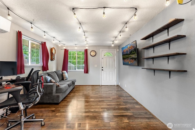 714 S 43rd St, Tacoma, WA 98418 - living area featuring wood finished floors, an AC wall unit, track lighting, and a textured ceiling