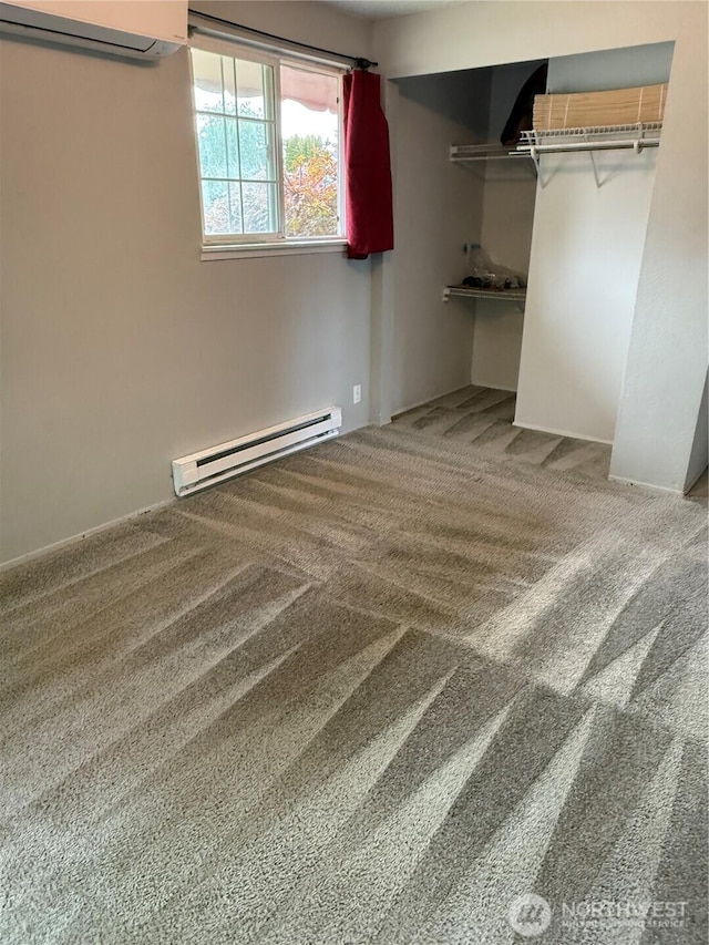714 S 43rd St, Tacoma, WA 98418 - unfurnished bedroom featuring baseboard heating, a wall mounted air conditioner, carpet, and a closet
