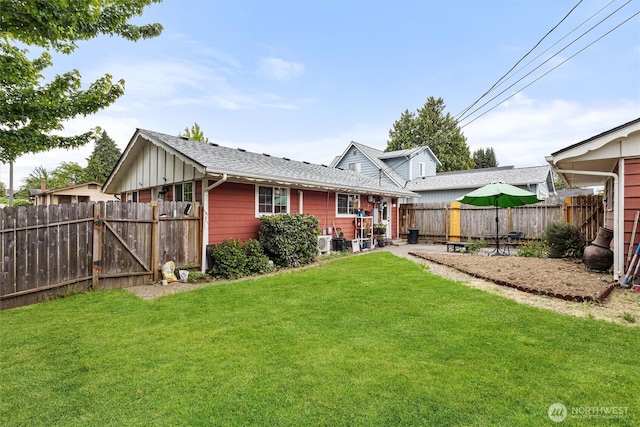 714 S 43rd St, Tacoma, WA 98418 - back of property featuring a fenced backyard, board and batten siding, a patio area, a gate, and roof with shingles