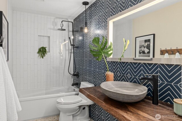 725 1st St S Unit 104, Kirkland, WA 98033 - full bathroom with tile walls, toilet, bathtub / shower combination, and a sink