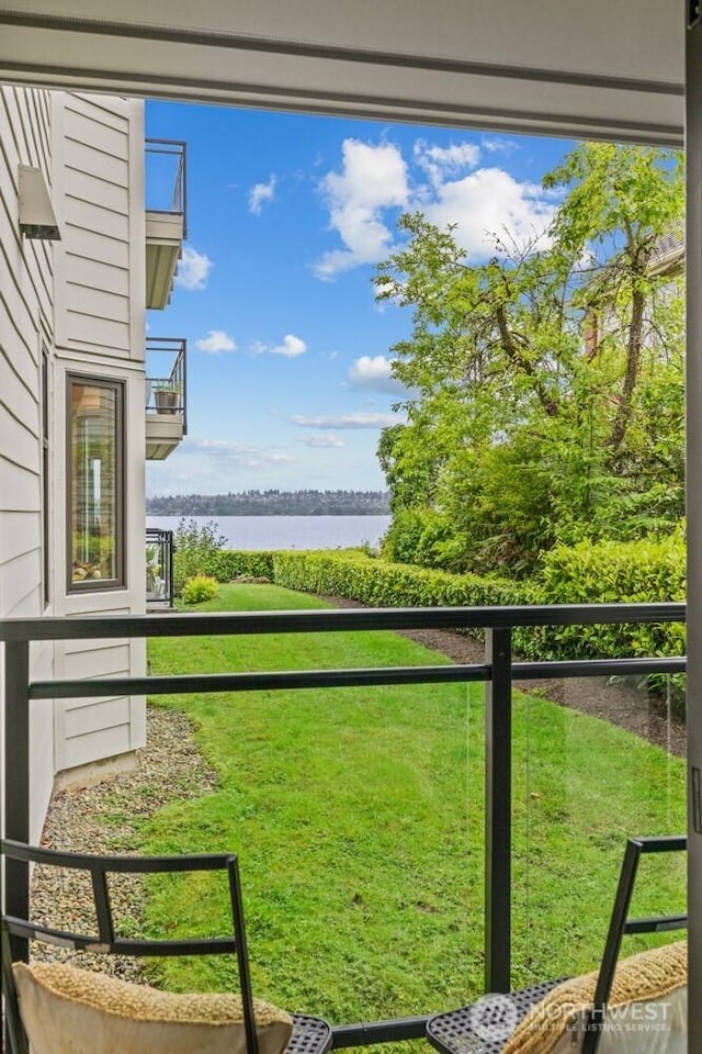 725 1st St S Unit 104, Kirkland, WA 98033 - view of green lawn with a water view and a balcony
