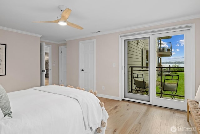 725 1st St S Unit 104, Kirkland, WA 98033 - bedroom featuring access to exterior, light wood-type flooring, ornamental molding, a water view, and baseboards