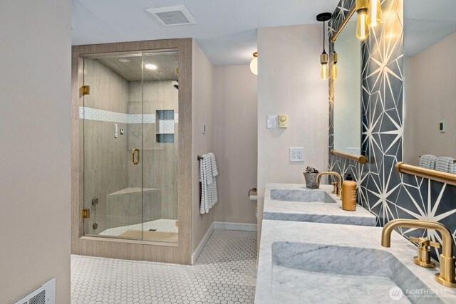 725 1st St S Unit 104, Kirkland, WA 98033 - bathroom featuring a stall shower, double vanity, and baseboards