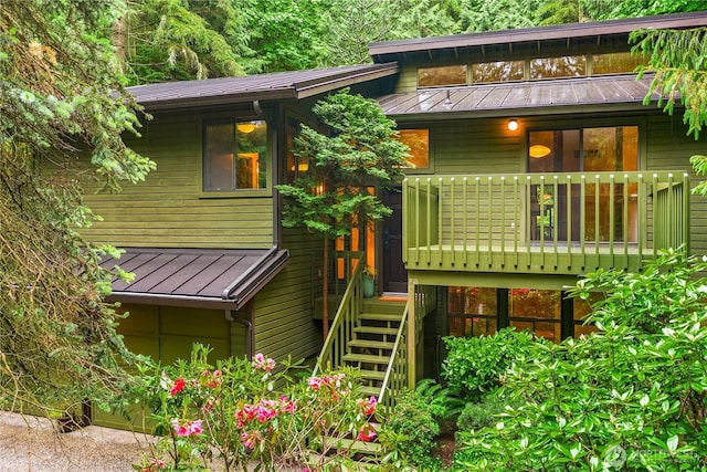 5471 NE Foster Rd, Bainbridge Island, WA 98110 - rear view of house featuring a standing seam roof, metal roof, and stairs