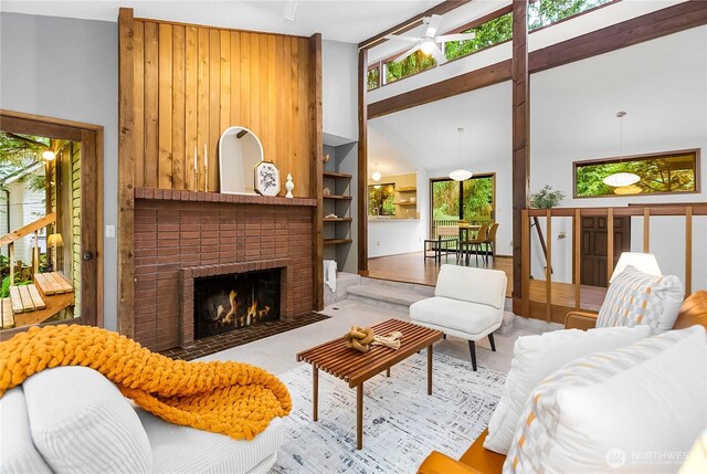 5471 NE Foster Rd, Bainbridge Island, WA 98110 - living room featuring a fireplace, high vaulted ceiling, and a ceiling fan