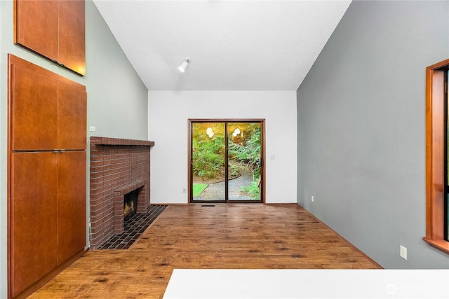 5471 NE Foster Rd, Bainbridge Island, WA 98110 - unfurnished living room featuring wood finished floors and a fireplace