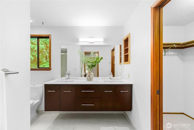 5471 NE Foster Rd, Bainbridge Island, WA 98110 - full bathroom with toilet, double vanity, and tile patterned flooring