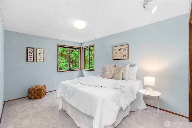 5471 NE Foster Rd, Bainbridge Island, WA 98110 - bedroom featuring carpet floors, baseboards, and a textured ceiling