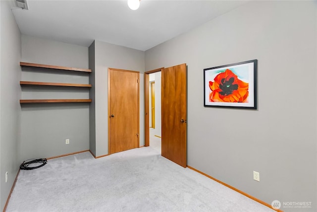 5471 NE Foster Rd, Bainbridge Island, WA 98110 - unfurnished bedroom featuring carpet flooring, baseboards, and a closet