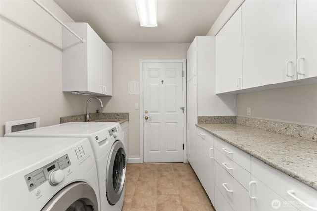 laundry room with washer and clothes dryer, cabinet space, and baseboards