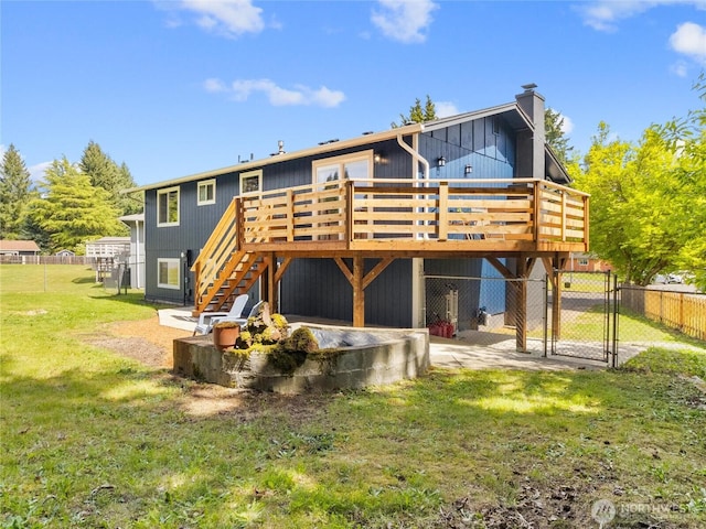 5431 Anton Ct SE, Olympia, WA 98501 - back of property with a gate, a wooden deck, stairs, and a chimney