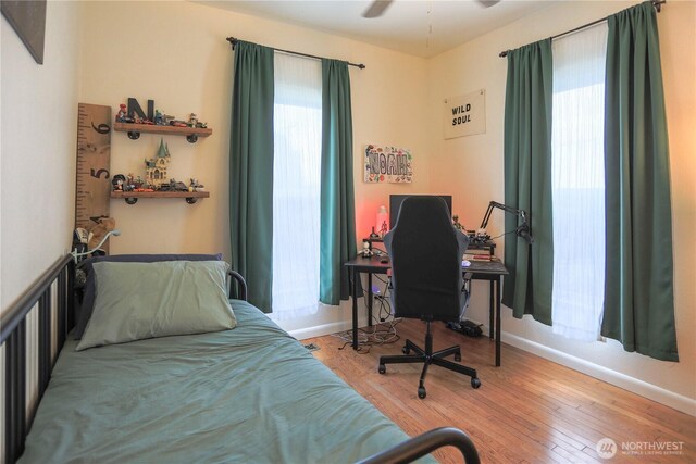 315 SW C St, Tumwater, WA 98512 - bedroom featuring multiple windows, wood finished floors, baseboards, and a desk