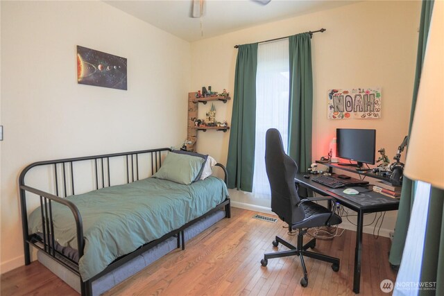315 SW C St, Tumwater, WA 98512 - bedroom with wood finished floors, baseboards, and an office area