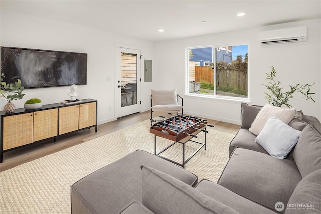 335 NW 47th St Unit B, Seattle, WA 98107 - living area featuring a wall mounted air conditioner, electric panel, wood finished floors, recessed lighting, and baseboards