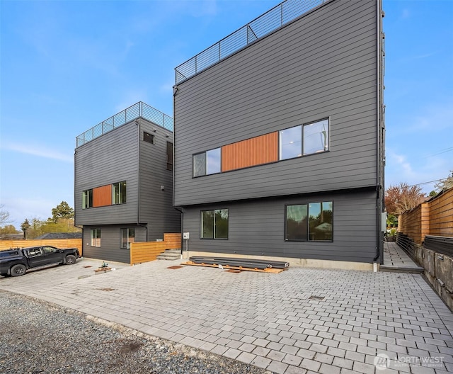 335 NW 47th St Unit B, Seattle, WA 98107 - back of property featuring a patio area and fence