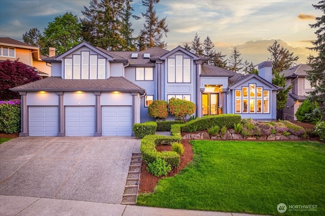 14259 SE 83rd St, Newcastle, WA 98059 - tudor-style house with driveway, a garage, a lawn, and stucco siding