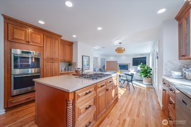 14259 SE 83rd St, Newcastle, WA 98059 - kitchen with appliances with stainless steel finishes, open floor plan, tasteful backsplash, light wood-type flooring, and light countertops