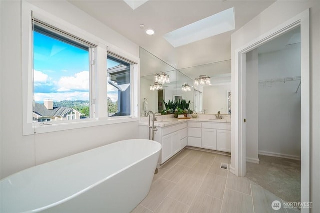 14259 SE 83rd St, Newcastle, WA 98059 - bathroom featuring a freestanding tub, double vanity, a walk in closet, and a chandelier
