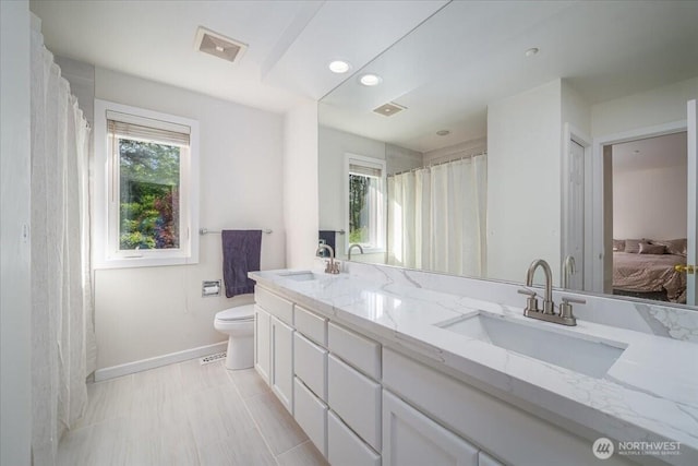 14259 SE 83rd St, Newcastle, WA 98059 - full bathroom featuring baseboards, toilet, double vanity, connected bathroom, and recessed lighting