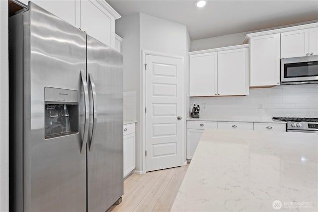 1194 Panoramic Loop, Bremerton, WA 98312 - kitchen featuring stainless steel appliances, white cabinetry, decorative backsplash, light stone countertops, and recessed lighting