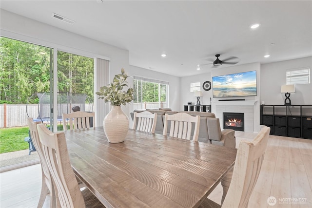 1194 Panoramic Loop, Bremerton, WA 98312 - dining space with a glass covered fireplace, ceiling fan, recessed lighting, light wood-style flooring, and healthy amount of natural light