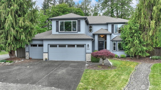 view of front of home with stone siding, roof with shingles, concrete driveway, and an attached garage