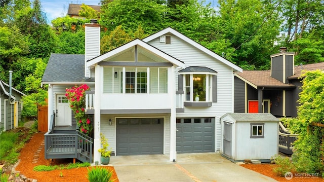 view of front of house with an attached garage, concrete driveway, a chimney, and a shingled roof
