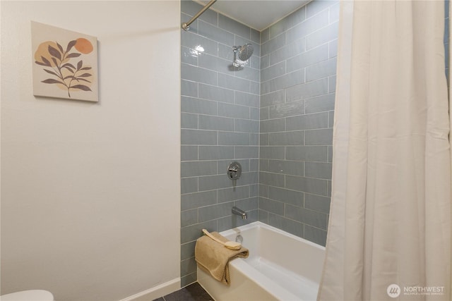 bathroom with shower / bathtub combination with curtain and baseboards
